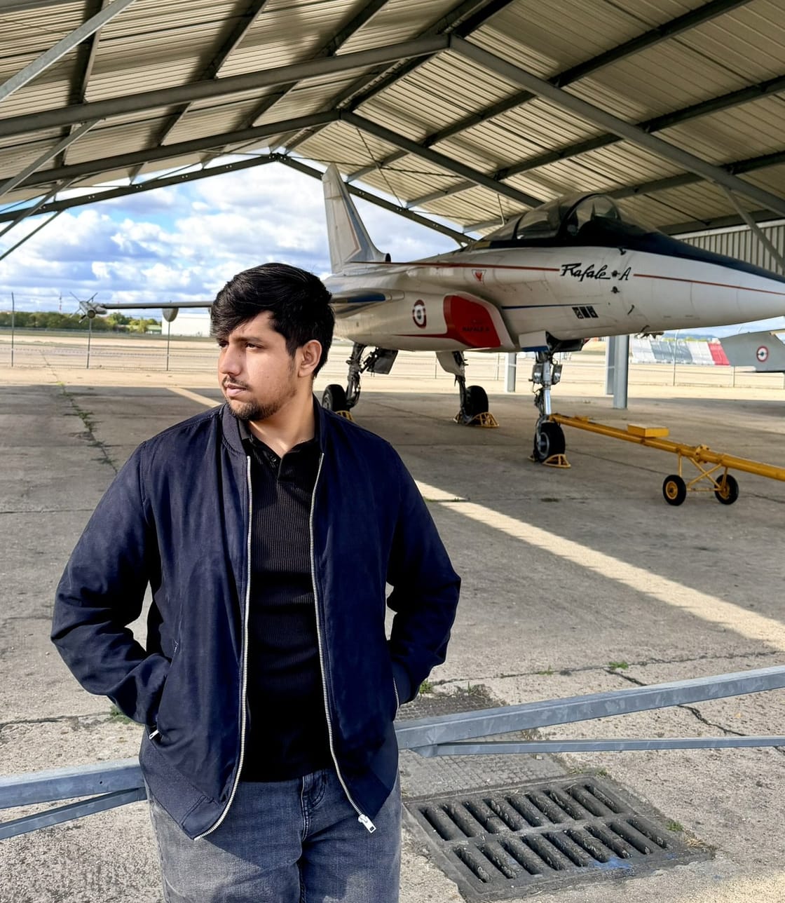 Sheharyar Ishfaq in a hangar beside a Rafale prototype